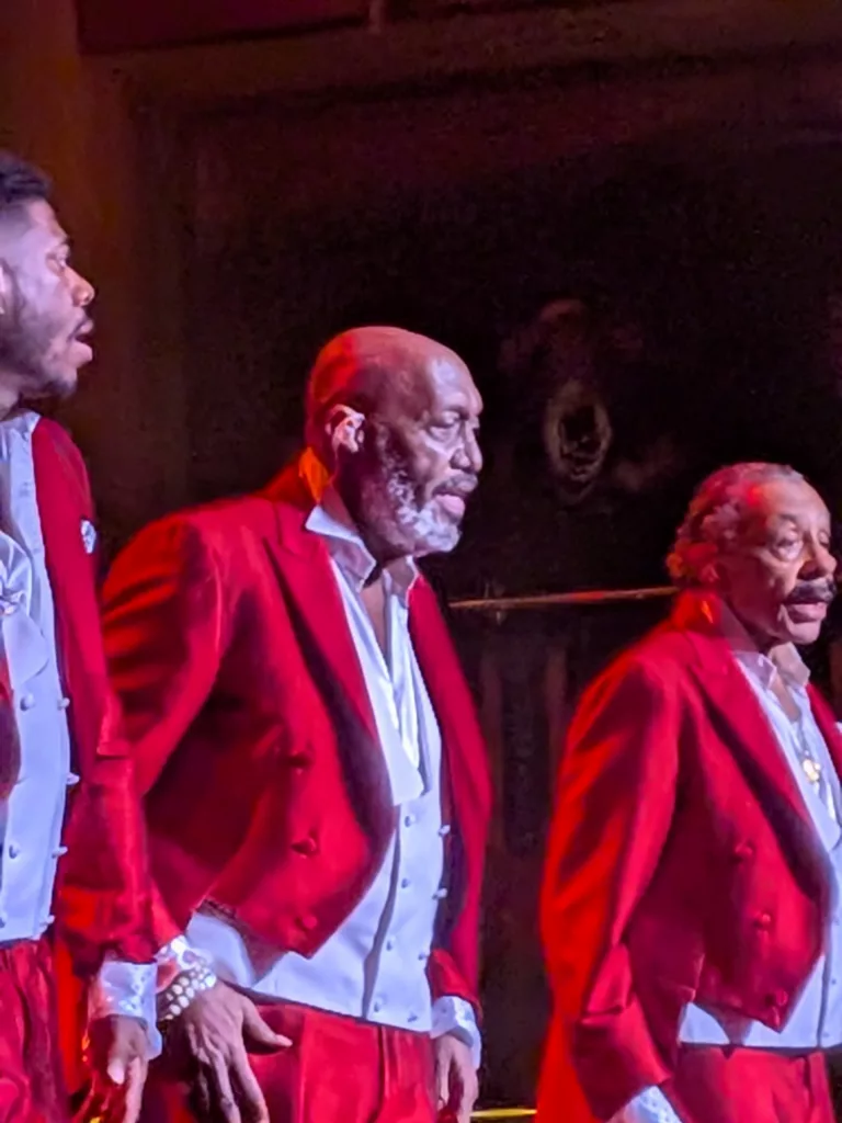 Otis Williams of the Temptations center.