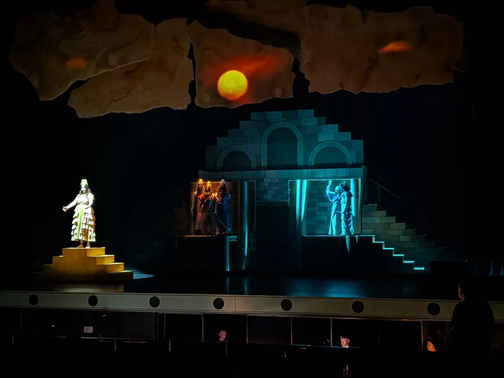 Projection seen mapped on soft goods and flying scenery.