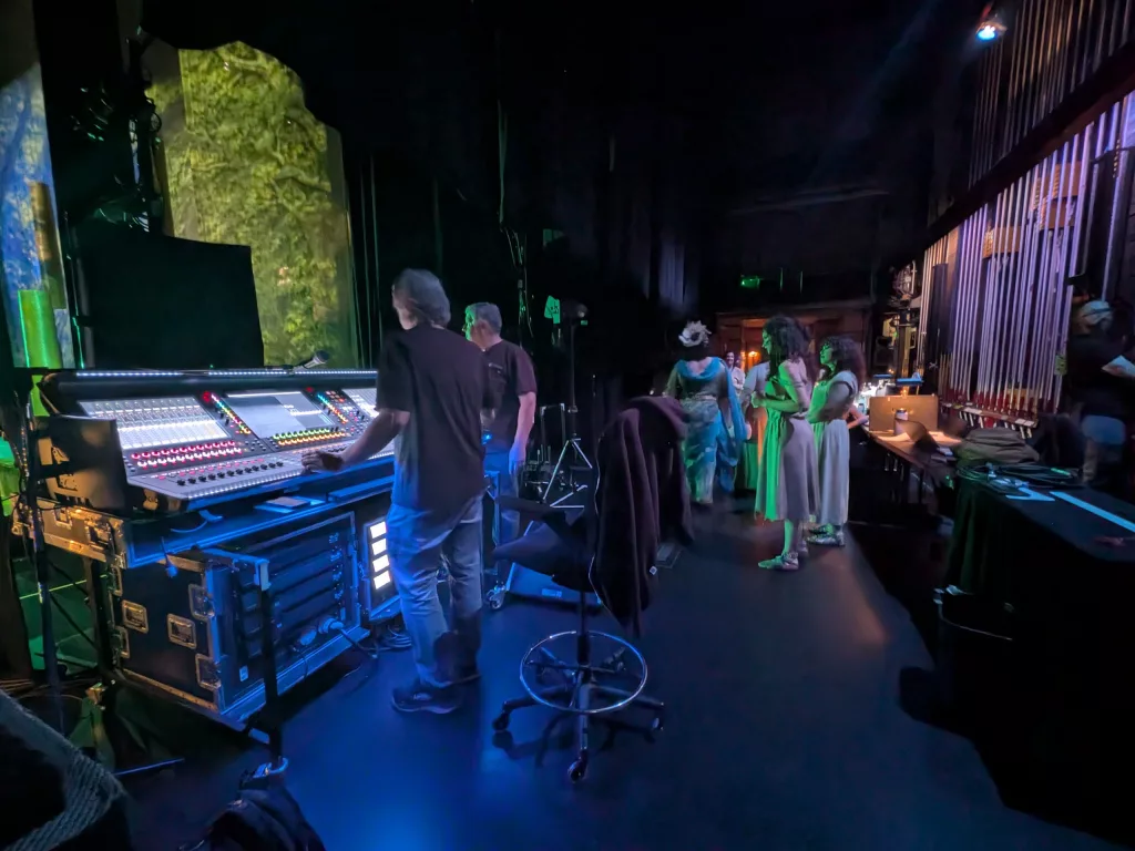 Backstage in the stage left wing. At the monitor board.