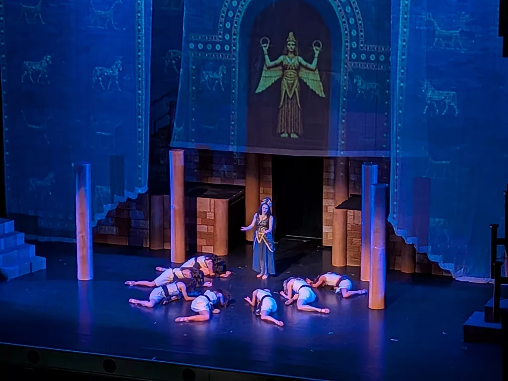 Projection seen mapped on soft goods and flying scenery.