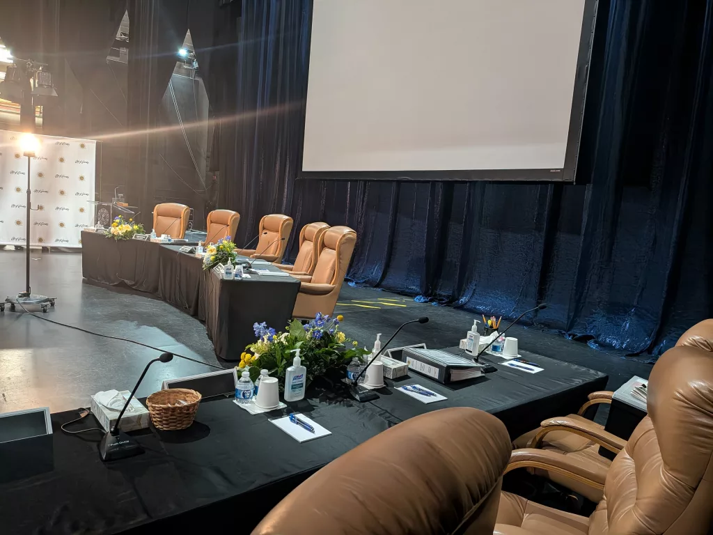 Stage left view of the stage reproduction of the city council chambers with the Imag screen.