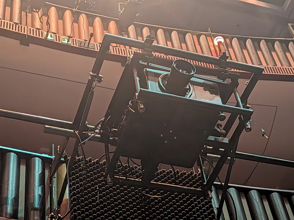 One of two in house Christie Roadster HD14K-M 1080 HD 3DLP projectors hanging on the balcony rail. (The other is out for maintenance.)